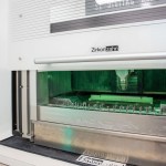 A close-up of a high-precision dental milling machine in a clinical lab setting