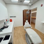 View of a surgical treatment room equipped with medical lighting and dental monitors