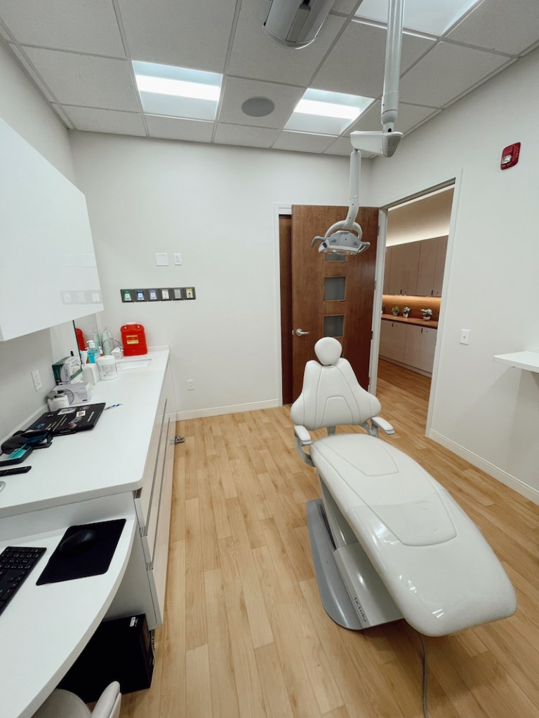 View of a surgical treatment room equipped with medical lighting and dental monitors