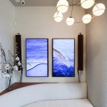 A patient recovery or rest area with a curved white sofa and a wall-mounted TV