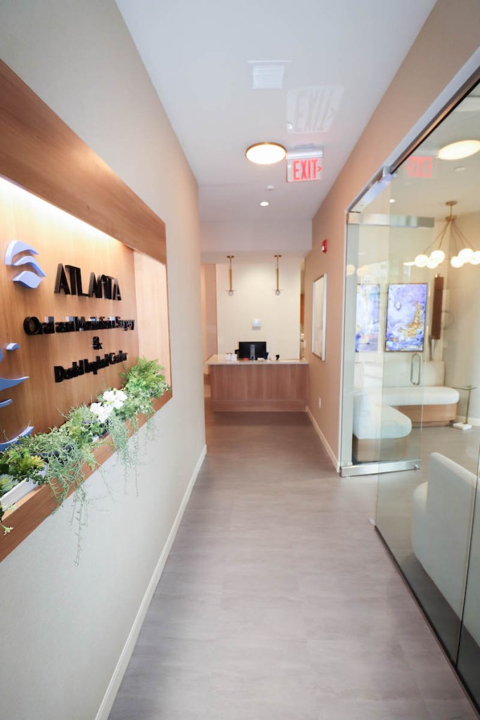 A bright, narrow hallway leading toward the reception area