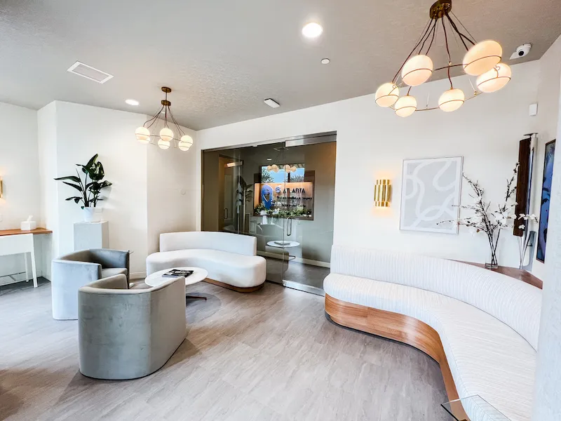 Wide-angle view of the reception lounge with modern furniture and a bright, open feel