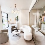 Minimalist lobby with curved white sofas, modern gray armchairs, and a large window
