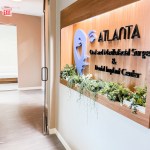 Interior view of the office entrance featuring the same branded signage on a light wood panel