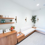 Brightly lit hallway with a seating bench and storage cabinets