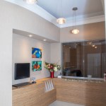 A compact clinical workstation with white cabinetry and a computer monitor built into a recessed nook