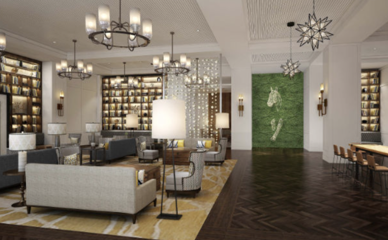 An upscale interior lounge or recovery area with dark wood shelving, chandeliers, and comfortable seating